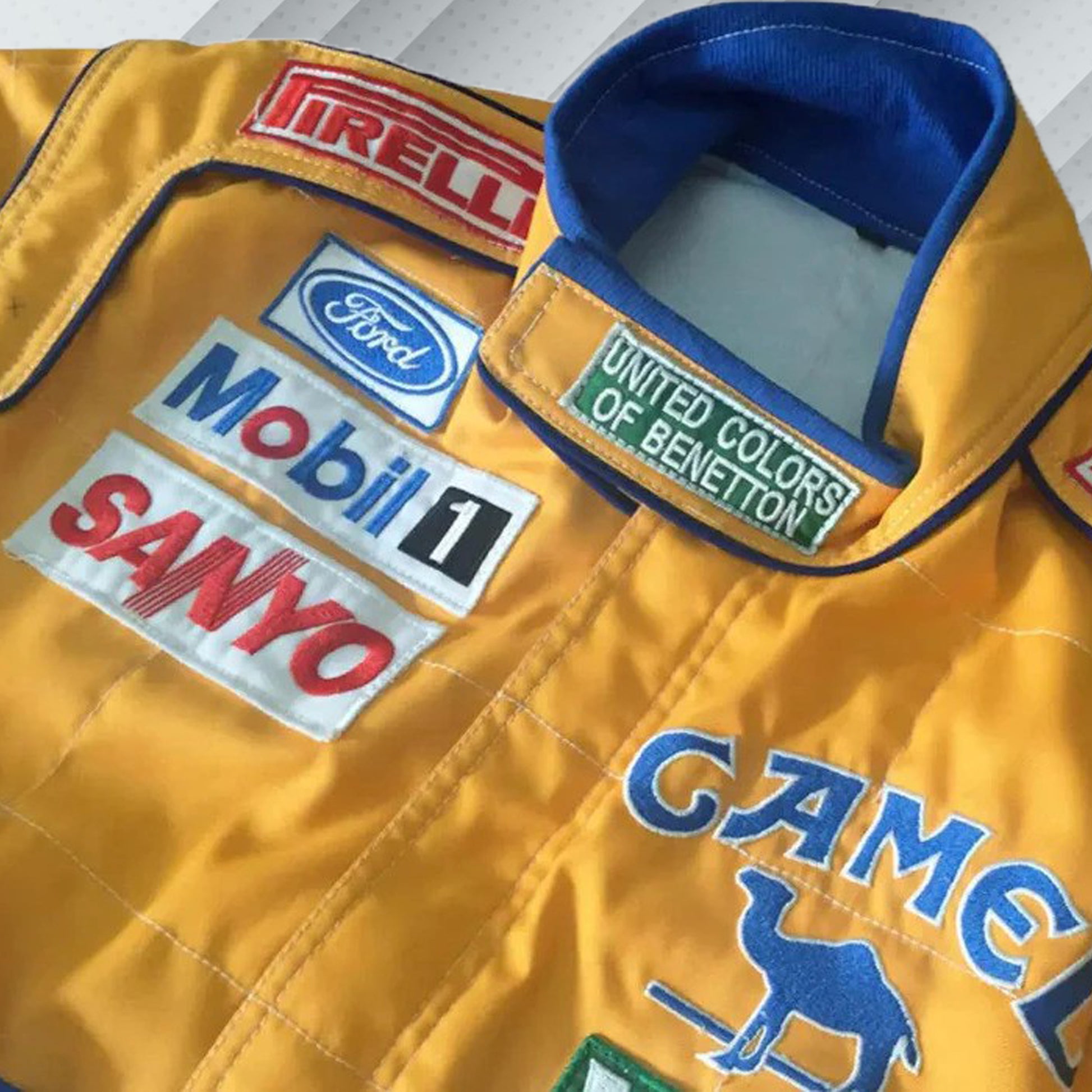 In 1992, Michael Schumacher appeared in F1 kit, sporting the Benetton Ford colours, its brightest shades of green, blue, and yellow, accompanied by a plethora of sponsors on the body. Once more the bodywork was named after Michael Schumacher. By this shirt we would like to let people taste the early days of the times of Michael Schumacher in Formula 1.