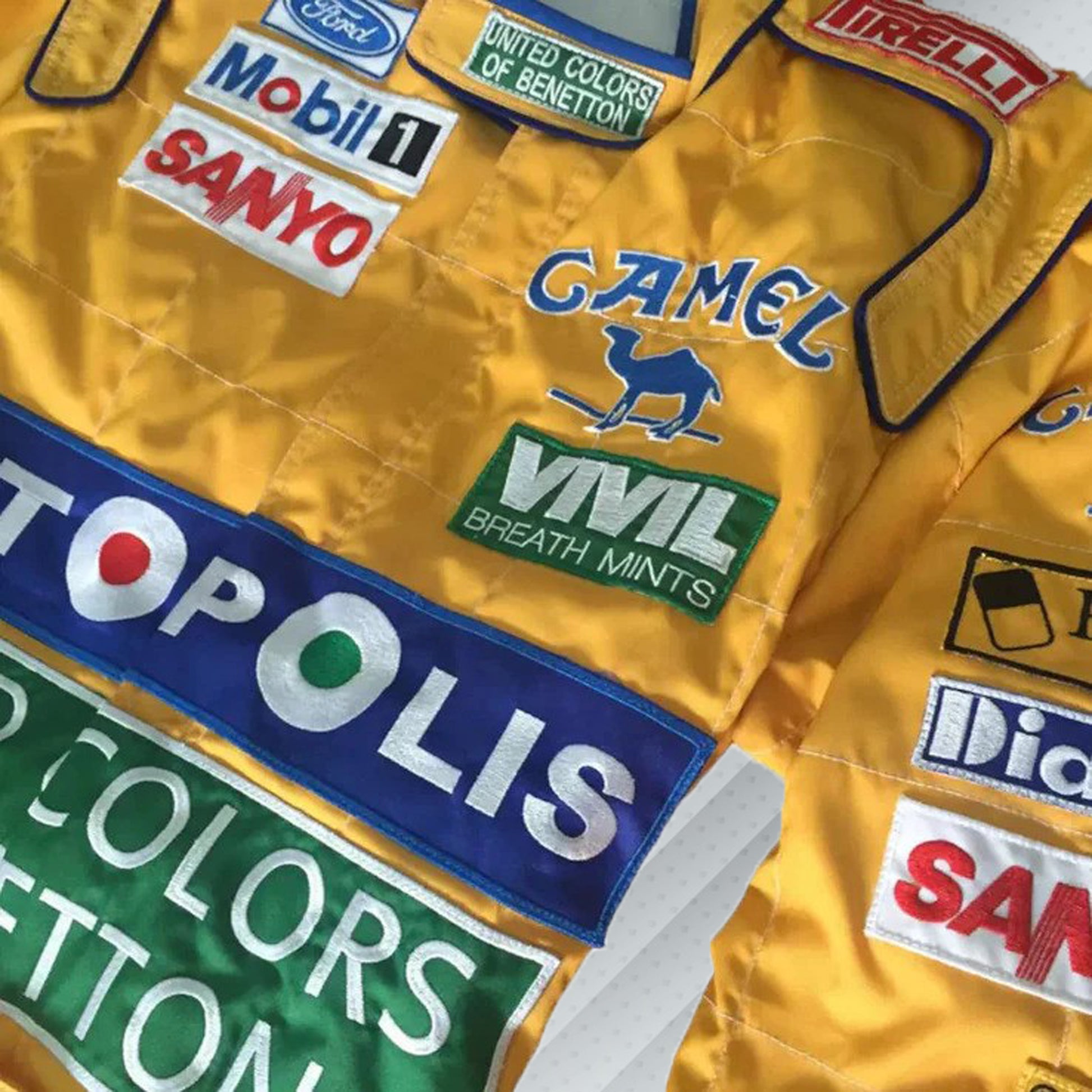 In 1992, Michael Schumacher appeared in F1 kit, sporting the Benetton Ford colours, its brightest shades of green, blue, and yellow, accompanied by a plethora of sponsors on the body. Once more the bodywork was named after Michael Schumacher. By this shirt we would like to let people taste the early days of the times of Michael Schumacher in Formula 1.